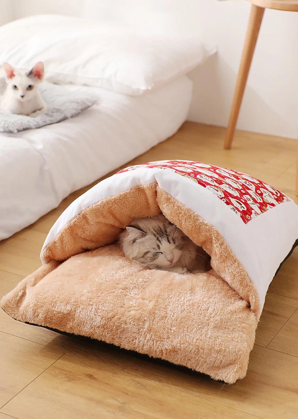 Pet sleeping bag bed beside a bed
